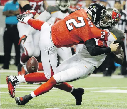  ?? DAVID GOLDMAN/AP ?? Tampa Bay’s Howard Jones puts a big hit on Atlanta quarterbac­k Matt Ryan as the Bucs upset the favoured Falcons 23-20.