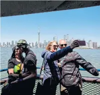  ?? CARLOS OSORIO/TORONTO STAR ?? Island visitors take the ferry over to the islands earlier this week.