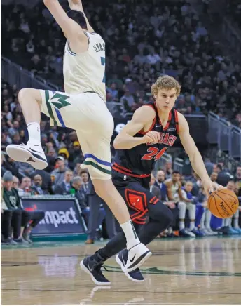  ?? AARON GASH/AP ?? Bulls big man Lauri Markkanen drives past Bucks forward Ersan Ilyasova in the first half Monday at Fiserv Forum in Milwaukee. Markkanen struggled with his shot and had no assists.