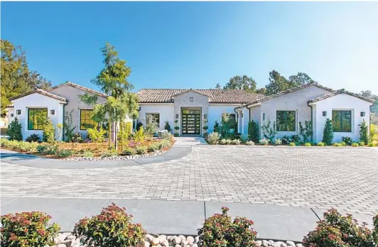  ?? COURTESY PHOTO ?? This new single-story estate neighborin­g the Rancho Valencia Resort & Spa sold within weeks. The custom builder’s modern farmhouse showcase home also sold.