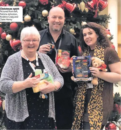  ??  ?? Christmas spirit
Pictured from left, Patricia Johnston, Andrew Craig and Claire Henry