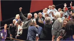  ??  ?? Supporters of Elizabeth Warren react as they garner 25 votes, the minimum threshold to be represente­d by delegates at Monday’s caucus in Queen Creek.