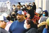  ?? CHRISTOPHE­R DOLAN AP ?? People line up on a sidewalk outside a GameStop store on Black Friday, in Dickson City, Pa.