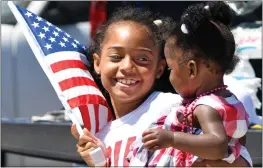  ?? PHOTO BY MILKA SOKO ?? Katiana King smiles at her younger sister Asheran at Moreno Valley’s Fourth of July parade in 2019. This year’s event starts at 9:30 a.m. Monday. The city also plans a Funfest at 2 p.m. at the Civic Center Amphitheat­er as well as fireworks.