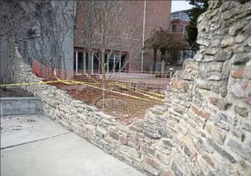  ?? Pam Panchak/Post-Gazette ?? A portion of the Winifred Lutz Garden wall along 500 Sampsonia Way on the North Side collapsed after rain fell Tuesday. Installed in 1993 at the Mattress Factory Museum, it was designed to look like an urban ruin.