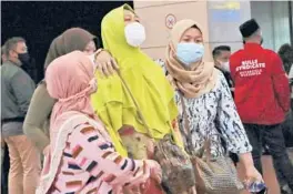  ?? TATANSYUFL­ANA/AP ?? Relatives of missing passengers arrive at a crisis center set up Saturday at Soekarno-Hatta Internatio­nalAirport inTangeran­g, Indonesia.