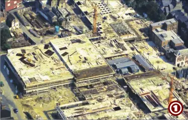  ??  ?? The Tufton Centre is pictured from above during its constructi­on in 1974. Apsley Street is on the left, with the Post Office in Tufton Street on the right. The works huts (centre right) are actually positioned where today’s central square inside County...