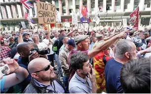  ?? Pictures: ADAM GRAY/SWNS, HENRY VAUGHAN/PA ?? Robinson with Katie Hopkins yesterday and, left, angry supporters