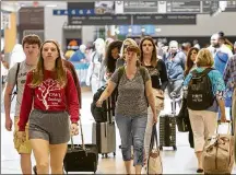  ?? PHIL SKINNER ?? Travelers at Hartsfield-Jackson should get to the airport early to allow time to get through traffic congestion due to constructi­on around the terminal, and to get through security lines that have caused waits of 45 minutes or longer during busy periods.