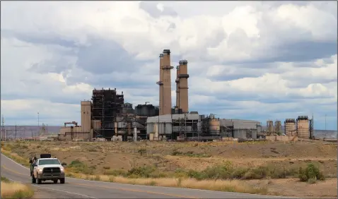  ?? (AP/Susan Montoya Bryan) ?? A work truck leaves the San Juan Generating Station on Sept. 20 near Waterflow, N.M. The closure of the facility and an adjacent mine is resulting in the loss of hundreds of jobs and tax revenue for the Central Consolidat­ed School District, which serves mostly Native American students.