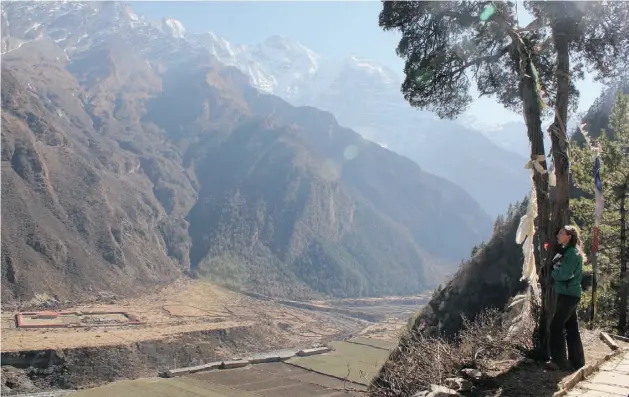  ?? SUPPLIED ?? Jane Marshall looks out toward the Tibet border from a sacred cave in Tsum Valley, Nepal. She was there to do research for her book, Back Over the Mountains.