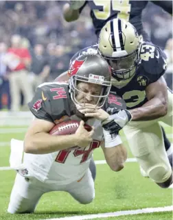  ?? WESLEY HITT/GETTY IMAGES ?? Buccaneers quarterbac­k Ryan Fitzpatric­k had a career day against the Saints, throwing for four touchdowns and running for another.