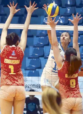  ?? MIGUEL DE GUZMAN ?? Air Force’s Joy Gazelle Cases spikes through the block of Power Smashers’ Mary Anne Esguerra and Vira May Guillema during their game in the Premier Volleyball League Open Conference at the Filoil Flying V Center in San Juan.