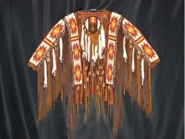  ??  ?? Cheri Cappello, Hides in the Mountains, ceremonial shirt, smoked buckskin with beadwork and authentic adornments, 48 x 50"