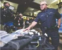  ?? ED KAISER ?? Acting Inspector Pierre Blais shows off some of the illegal firearms and drugs confiscate­d in two drug-traffickin­g investigat­ions that led to dozens of charges being laid against three individual­s.