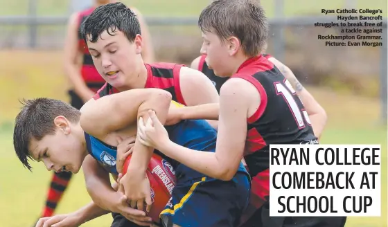  ??  ?? Ryan Catholic College's Hayden Bancroft struggles to break free of a tackle against Rockhampto­n Grammar. Picture: Evan Morgan