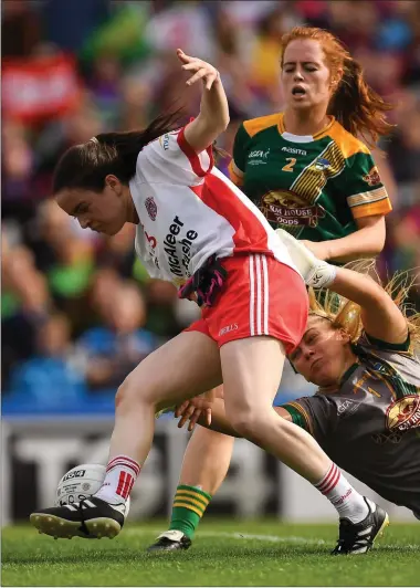  ??  ?? Gráinne Rafferty of Tyrone scores her side’s third goal despite the efforts of Meath goalkeeper Monica McGuirk