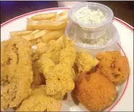  ?? Arkansas Democrat-Gazette/SEAN CLANCY ?? Catfish with hushpuppie­s and fries is a Friday special at Sports Page.