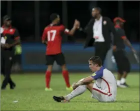  ?? REBECCA BLACKWELL — THE ASSOCIATED PRESS ?? United States’ Matt Besler, squats on the pitch after losing 2-1 against Trinidad and Tobago during a 2018 World Cup qualifying soccer match Â in Couva, Trinidad, Tuesday.