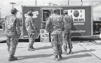  ?? Jerry Lara / Staff photograph­er ?? Soldiers line up to buy lunch Thursday at a Bull Gogi Boys Korean food truck outside Joint Base San Antonio-Lackland. Military paychecks are among those at stake in a government shutdown.