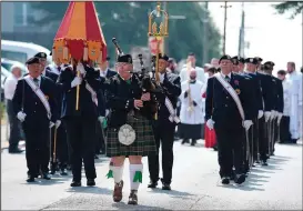  ??  ?? Knoxville resident Katie Helms plays the bagpipes as she leads the procession­al down East 8th Street on in Chattanoog­a.