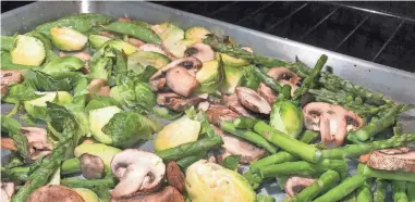  ?? LAURA GUTSCHKE/REPORTER-NEWS ?? Greet spring with this recipe for roasted sugar snap peas, asparagus and brussels sprouts.