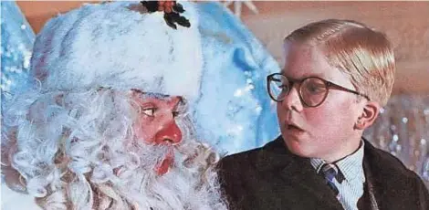  ?? GETTY IMAGES ?? Ralphie (Peter Billingsle­y) is stymied by Santa in a scene from “A Christmas Story.”