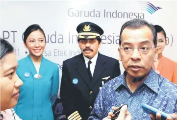  ??  ?? Former Chief Executive Officer of Indonesia’s Garuda airline Emirsyah Satar, accompanie­d by airline crew, speaks to reporters during the airline’s initial public listing in Jakarta February 11, 2011. Indonesia’s anti-corruption agency said it was...