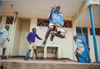  ?? BRIAN INGANGA / ASSOCIATED PRESS ?? Students joke around and play at the Olympic Primary School in Kibera, one of the poorest areas in the Kenyan capital Nairobi, on Monday.