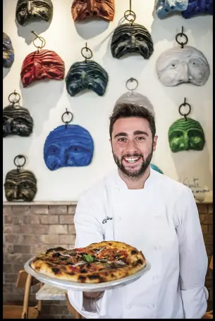  ??  ?? Ciro Oliva, chef at Concettina ai Tre Santi, is known for playfulnes­s in the kitchen. He also cooks up classics like pizza pacchianel­la, with anchovies, San Marzano tomatoes, olives and capers.