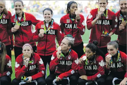  ??  ?? Members of the Canadian women’s soccer team celebrate after winning the bronze medal in Rio. Each player will receive $10,000 in prize money, courtesy of the Canadian Olympic Committee’s Athlete Excellence Fund, but the taxman will take a share of...