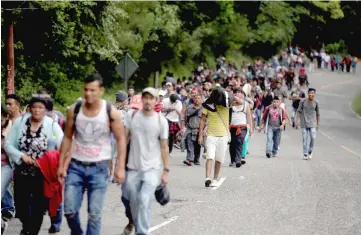  ??  ?? Honduran migrants, part of a caravan trying to reach the US, are seen during a new leg of their travel in Esquipulas, Guatemala. — Reuters photo