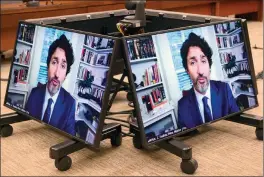  ??  ?? The Canadian Press
Prime Minister Justin Trudeau appears as a witness via videoconfe­rence during a House of Commons finance committee in the Wellington Building.