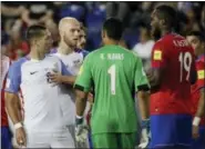  ?? THE ASSOCIATED PRESS ?? U.S. forward Clint Dempsey, left, is restrained by teammate Michael Bradley during an argument with Costa Rica defender Kendall Waston (19) on Friday.