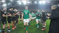  ?? REUTERS FILE ?? Johnny Sexton (center) is flanked by a New Zealand players guard of honor after helping Ireland beat the All Blacks in Dublin on Nov 17.