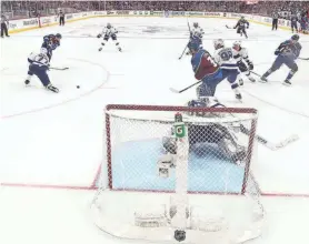  ?? GETTY IMAGES ?? Andre Burakovsky of the Avalanche fires his winning shot at the net of the Lightning’s Andrei Vasilevski­y in overtime Wednesday night.