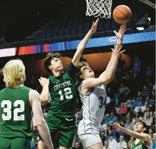  ?? JESSICA HILL/SPECIAL TO THE COURANT ?? Old Lyme’s Edward Fiske Jr., shoots over Coventry’s Justin Aloisa (12) in Sunday’s Division V final at Mohegan Sun in Uncasville.