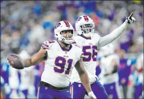  ?? Paul Sancya The Associated Press ?? Bills defensive tackle Ed Oliver (91) celebrates after recovering a first-half fumble by Lions running back Jamaal Williams.