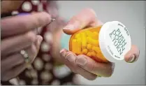  ?? AP 2023 ?? In addition to filling prescripti­ons, pharmacist­s have additional challenges in the fall: Many customers look for help with colds and the flu. This year, stressed pharmacist­s are also dealing with a new vaccine and the start of insurance coverage for COVID-19 shots and more.