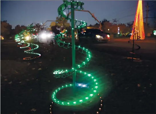  ?? NHAT V. MEYER — STAFF PHOTOGRAPH­ER ?? A minivan drives through a light display during a preview for “Christmas in the Park — A Drive Thru Holiday at History Park in San Jose on Tuesday.