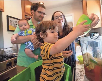  ?? CHRIS KOHLEY, MILWAUKEE JOURNAL SENTINEL ?? Arielle and Geoff Bloom help their son Ezra add ingredient­s to the blender to create gazpacho. Baby Gideon looks on.