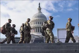  ?? J. Scott Applewhite / Associated Press ?? National Guard troops on Sunday reinforce security around the U.S. Capitol ahead of the inaugurati­on of President-elect Joe Biden and Vice President-elect Kamala Harris in Washington.