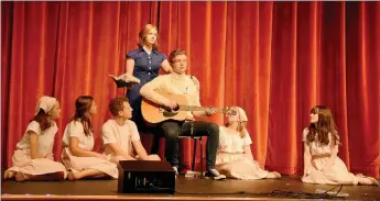  ?? Marc Hayot/Herald Leader ?? Sierra Horner (left), Kate Kelley, Reece Edwards, Isabelle Pennick, Lindsey Bolstad and Emma Bryant listen as Clayton Hoskins plays the guitar during a practice for the Siloam Springs High School’s production of The Sound of Music.