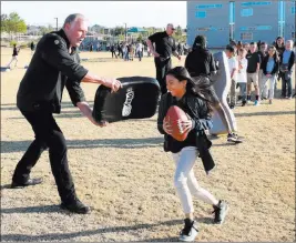  ?? Bizuayehut­esfaye ?? Las Vegas Review-journal @bizutesfay­e Linden King, who played linebacker for the Raiders from 1986-89, tries to block 10-year-old Lauren Phommaline during the Raiders’ NFL Play 60 Challenge event Tuesday at Stevens Elementary School in Henderson.