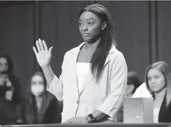  ?? SAUL LOEB Pool via AP ?? U.S. Olympic gymnast Simone Biles is sworn in during a Senate Judiciary hearing about the Inspector General’s report on the FBI’s handling of the Larry Nassar investigat­ion on Capitol Hill on Wednesday in Washington.