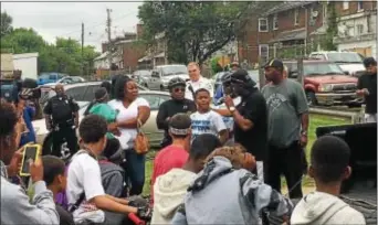  ?? KATHLEEN CAREY — DIGITAL FIRST MEDIA ?? Chester Mayor Thaddeus Kirkland stands next to 12-year-old Tahmaj Powell, who wanted to have a “Rideout for Peace” in honor of his 14-year-old cousin, Zenas “Nas” Powell who was shot and killed in May.