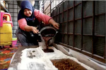  ?? ?? Roziah pours the hot ‘nise’ mixture onto a wooden surface, dusted with wheat flour.