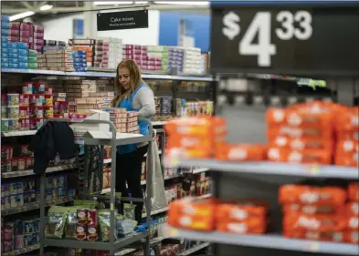  ?? (AP/Eduardo Munoz Alvarez) ?? A worker organizes items at a Walmart Supercente­r in North Bergen, N.J., on Feb. 9, 2023.