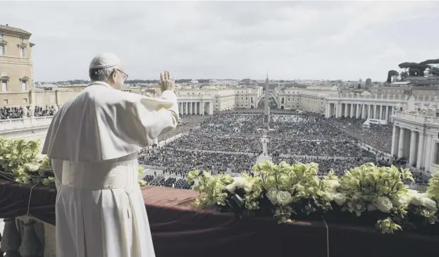  ?? PICTURES: AFP ?? 0 Pope Francis delivers the ‘Urbi et Orb’i blessing to the city and world from the balcony of St Peter’s Basilica after the Easter Mass yesterday