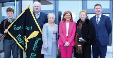  ??  ?? Liamh Ó Caoimh (Rang 6) carrying the school flag into the new extension, accompanie­d by Padraig Mac an Fhailligh, Maire Uí Bhriain, Síle Ní Ríordain (Vice Principal), Padraigín Bn Uí Loingsigh and Dónal Ó Murchú pictured at the opening of the new...